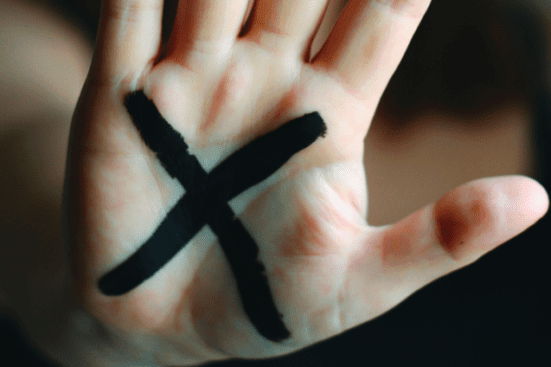 A hand with an "x" on the palm / Photo by Lauren Bates