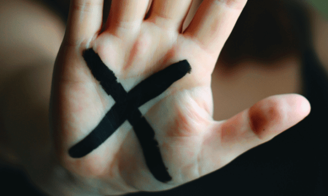 A hand with an "x" on the palm / Photo by Lauren Bates