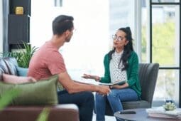 Female therapist talking to a male client.