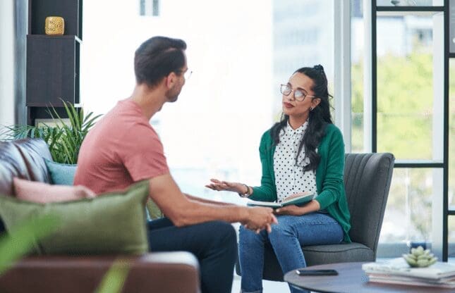 Female therapist talking to a male client.