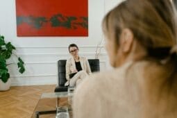 Two women sitting in a therapy session / Photo by Mart Productions