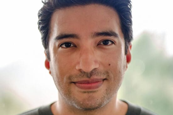 Image of Yung Pueblo facing the camera and smiling