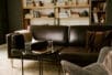 therapist's office with a brown leather couch and gray chair facing each other