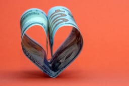 Two 100 dollar bills folded together to form a heart