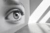 An image of an enormous eye painted across the surface of one wall in an empty room